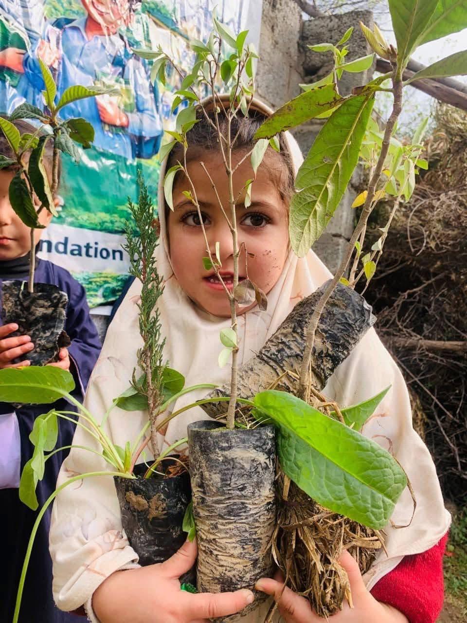 Children with tree saplings - school plantation and environmental awareness