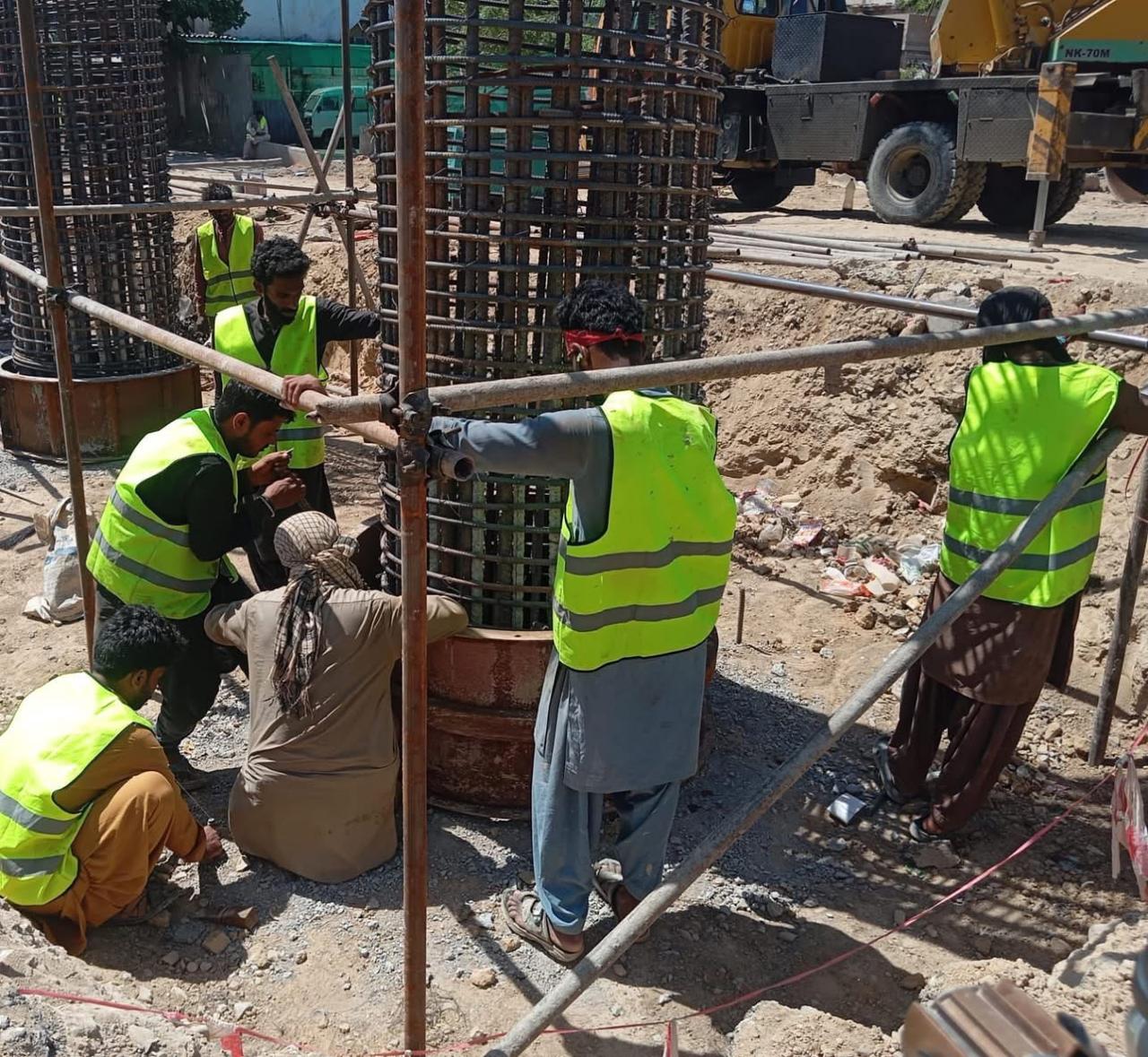 Construction workers on structural foundation - civil engineering works